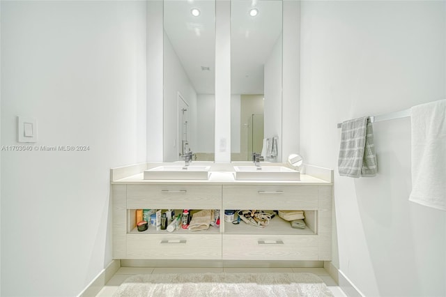 bathroom with tile patterned flooring and vanity