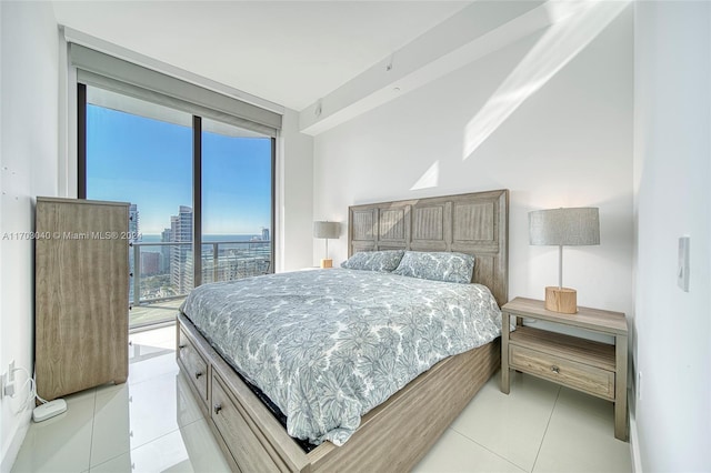 bedroom with access to exterior and light tile patterned floors