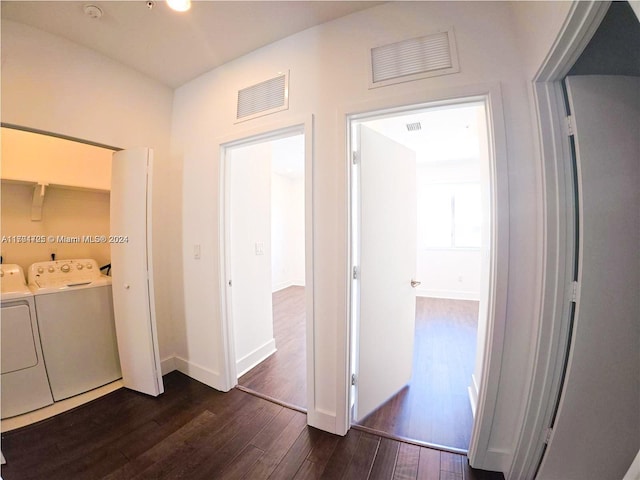 hallway with washing machine and dryer and dark hardwood / wood-style flooring