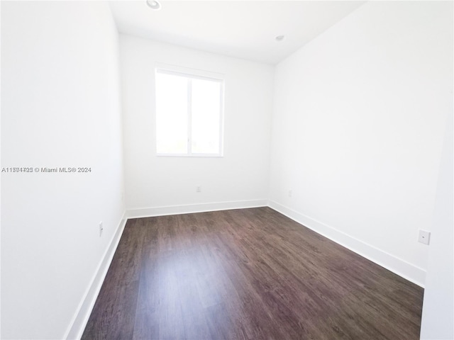 spare room with dark hardwood / wood-style flooring