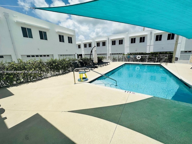 view of swimming pool with a patio