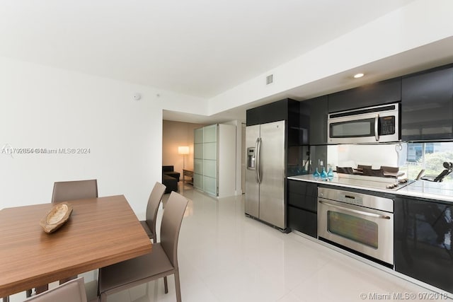 kitchen featuring light tile patterned floors and stainless steel appliances