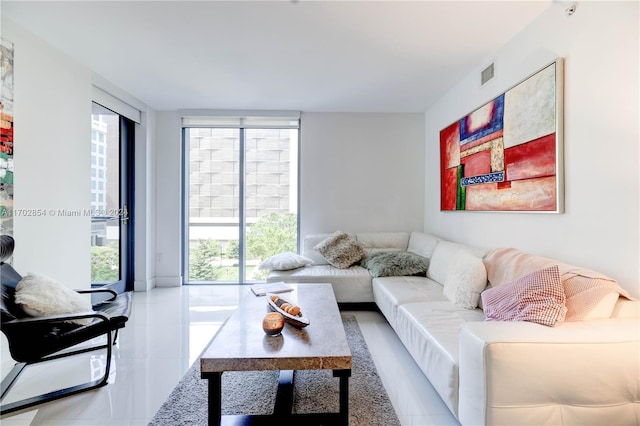 tiled living room with a wall of windows