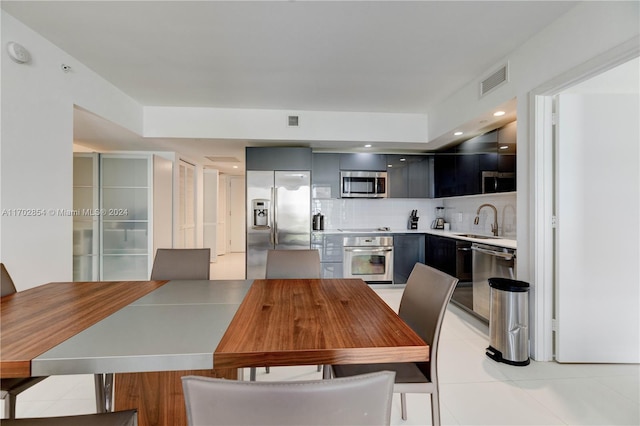 dining space with sink and light tile patterned floors