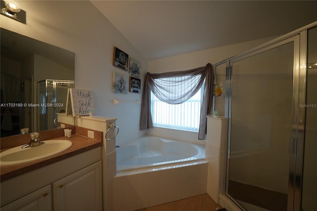 bathroom featuring plus walk in shower, tile patterned floors, vanity, and vaulted ceiling