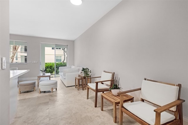 sitting room with lofted ceiling