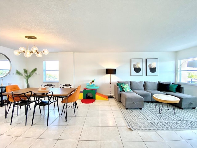 interior space featuring a chandelier, a healthy amount of sunlight, and a textured ceiling