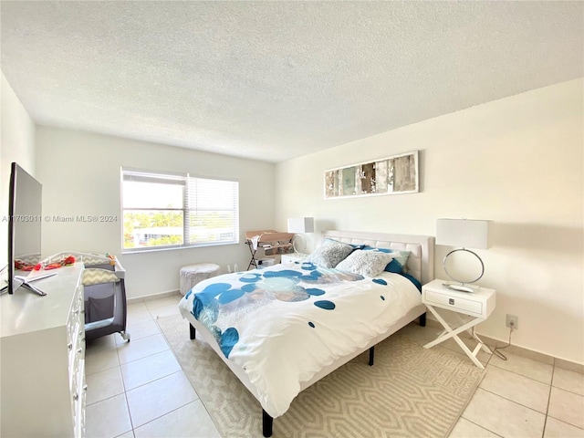 tiled bedroom with a textured ceiling