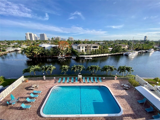 view of pool featuring a patio and a water view