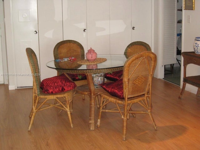 dining space with wood-type flooring