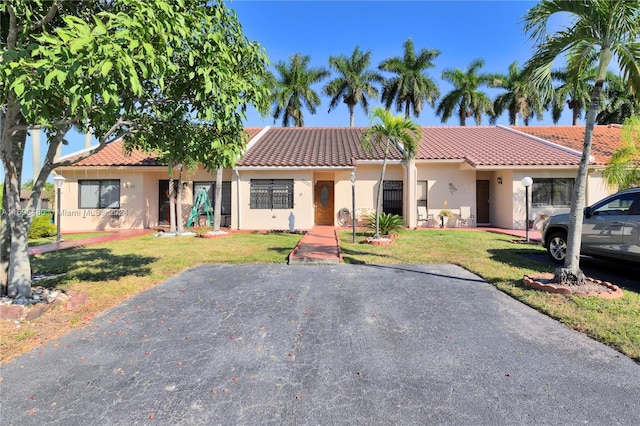 mediterranean / spanish house with a front yard