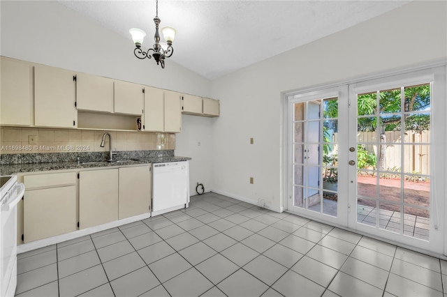 kitchen featuring sink, decorative light fixtures, cream cabinetry, vaulted ceiling, and white appliances