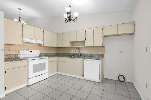 kitchen with white appliances, cream cabinets, sink, vaulted ceiling, and tasteful backsplash