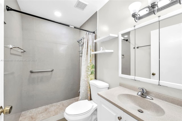 bathroom with vanity, toilet, and walk in shower