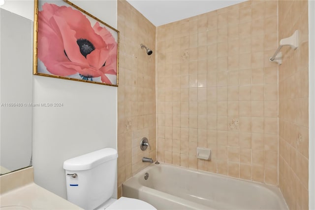 bathroom with tiled shower / bath combo and toilet