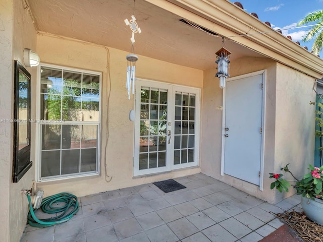 entrance to property with french doors and a patio area