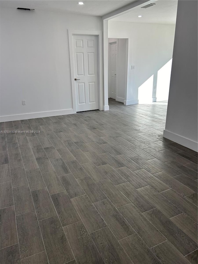 empty room with dark hardwood / wood-style flooring