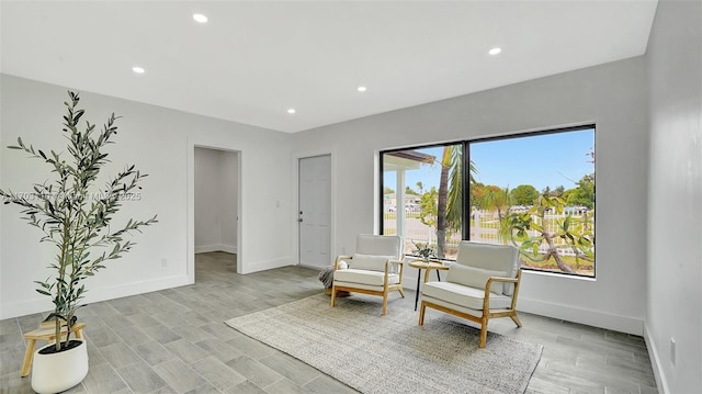 sitting room featuring light wood-type flooring, baseboards, and recessed lighting