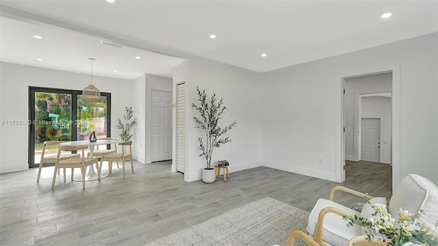 dining space with recessed lighting, wood finish floors, and baseboards