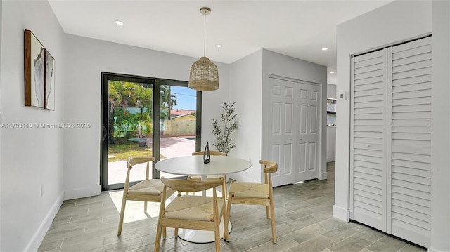 dining room with light wood-style floors, recessed lighting, and baseboards