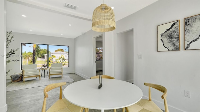 dining area featuring light wood-type flooring, baseboards, visible vents, and recessed lighting