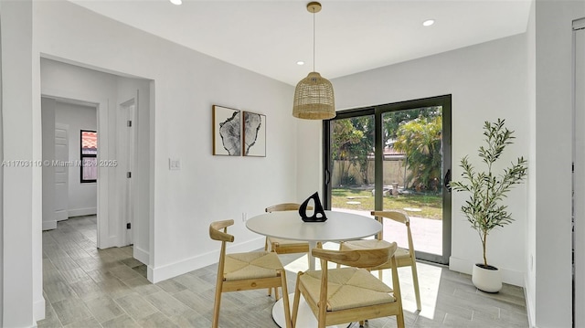 dining space featuring light wood-style flooring, baseboards, and recessed lighting