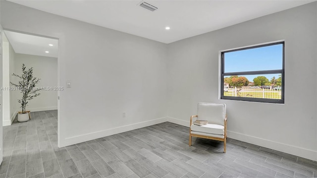 unfurnished room with light wood finished floors, recessed lighting, visible vents, and baseboards