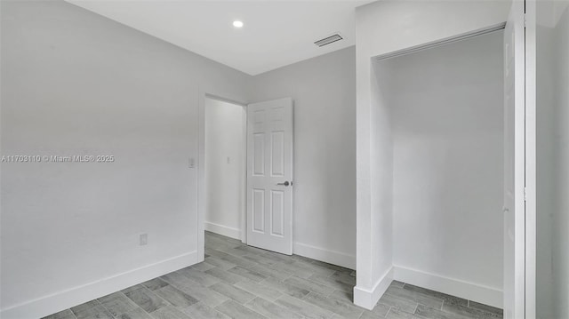 unfurnished bedroom featuring light wood-type flooring, visible vents, and baseboards