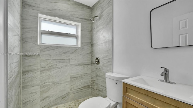 full bath featuring toilet, a stall shower, and vanity