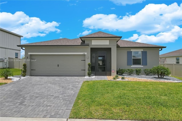 view of front of house with a front yard and a garage