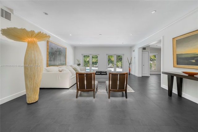 living room featuring french doors and crown molding