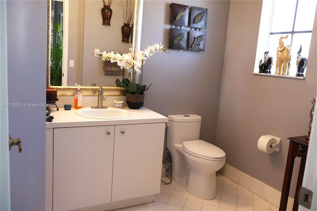 half bathroom featuring tile patterned flooring, vanity, and toilet