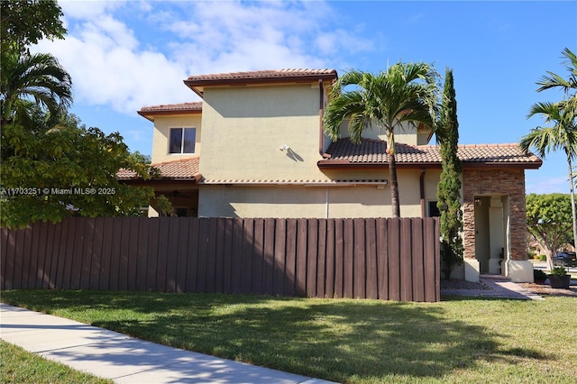 8778 SW 222nd Ter, Cutler Bay, FL 33190 - view of side of home with a tiled roof, stucco siding, and stone siding