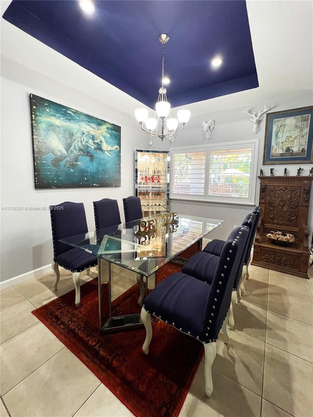 tiled dining space featuring baseboards, an inviting chandelier, a tray ceiling, and recessed lighting