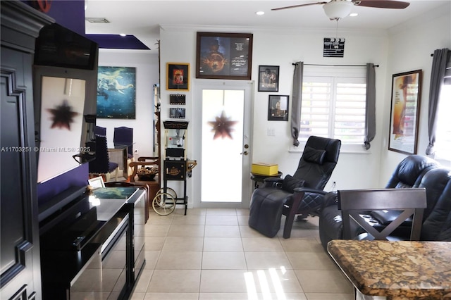 living area featuring light tile patterned floors, ceiling fan, recessed lighting, visible vents, and ornamental molding