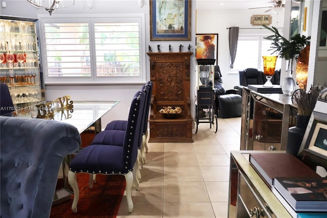 interior space featuring ceiling fan, light tile patterned flooring, and a healthy amount of sunlight