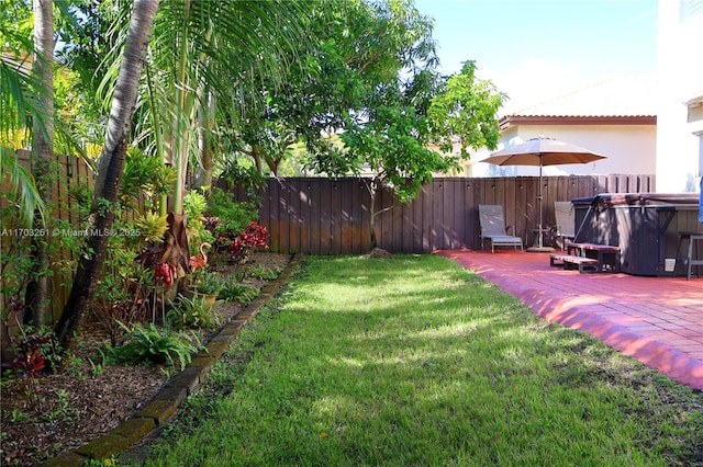 view of yard with fence, a hot tub, and a patio area