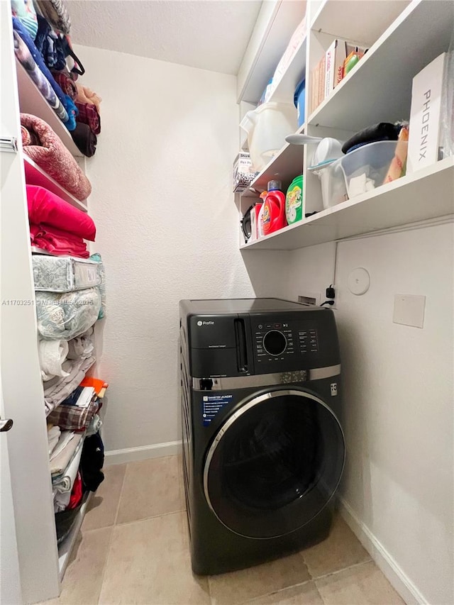 washroom with washer / dryer, laundry area, and baseboards