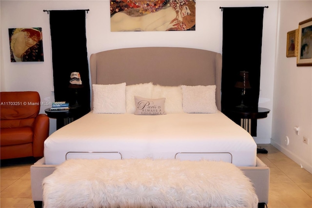 bedroom featuring baseboards and tile patterned floors