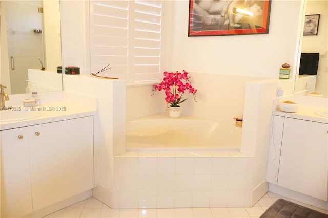 bathroom featuring a bath, tile patterned flooring, and vanity