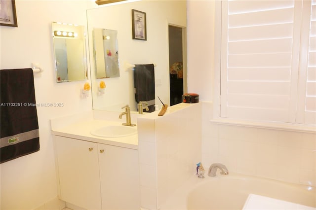 full bathroom featuring vanity and a bath