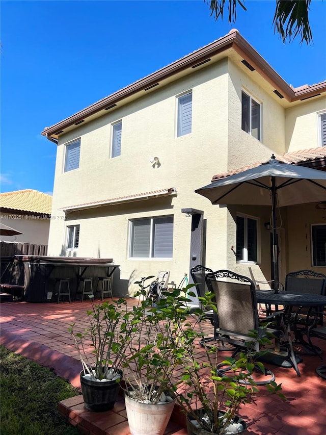 back of house with a patio area, fence, and stucco siding