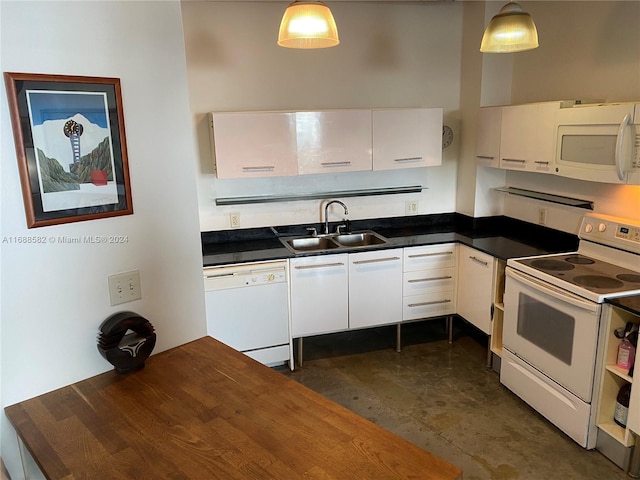 kitchen with white cabinetry, hanging light fixtures, and white appliances