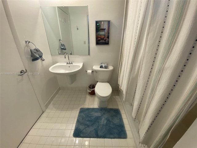 bathroom with sink, tile patterned flooring, and toilet