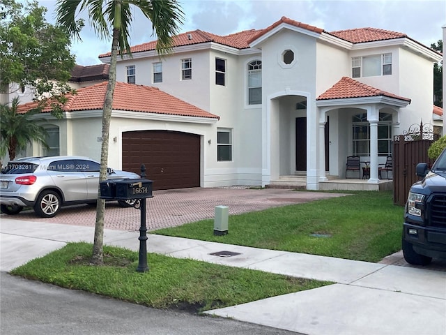 mediterranean / spanish house featuring a front yard