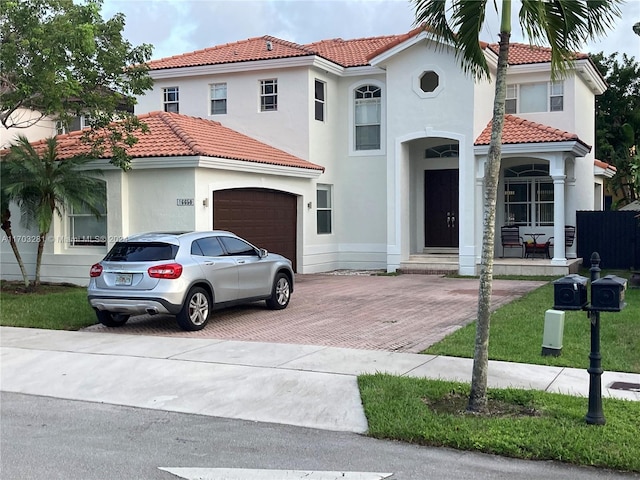 mediterranean / spanish-style house with a garage