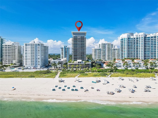 bird's eye view featuring a water view and a beach view