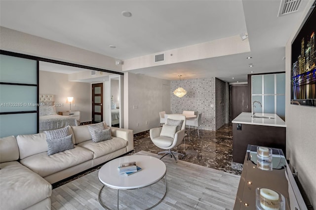 living room with light hardwood / wood-style floors and sink