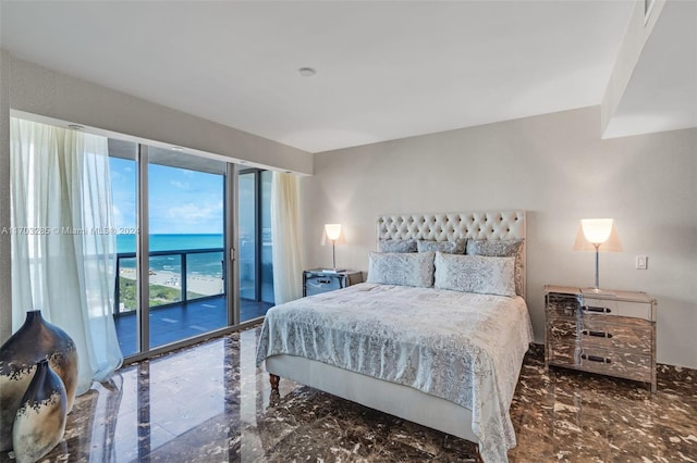 bedroom with access to exterior and a water view