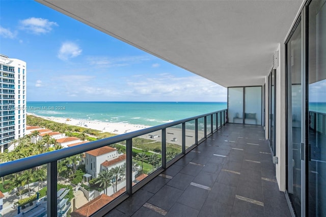 balcony with a beach view and a water view